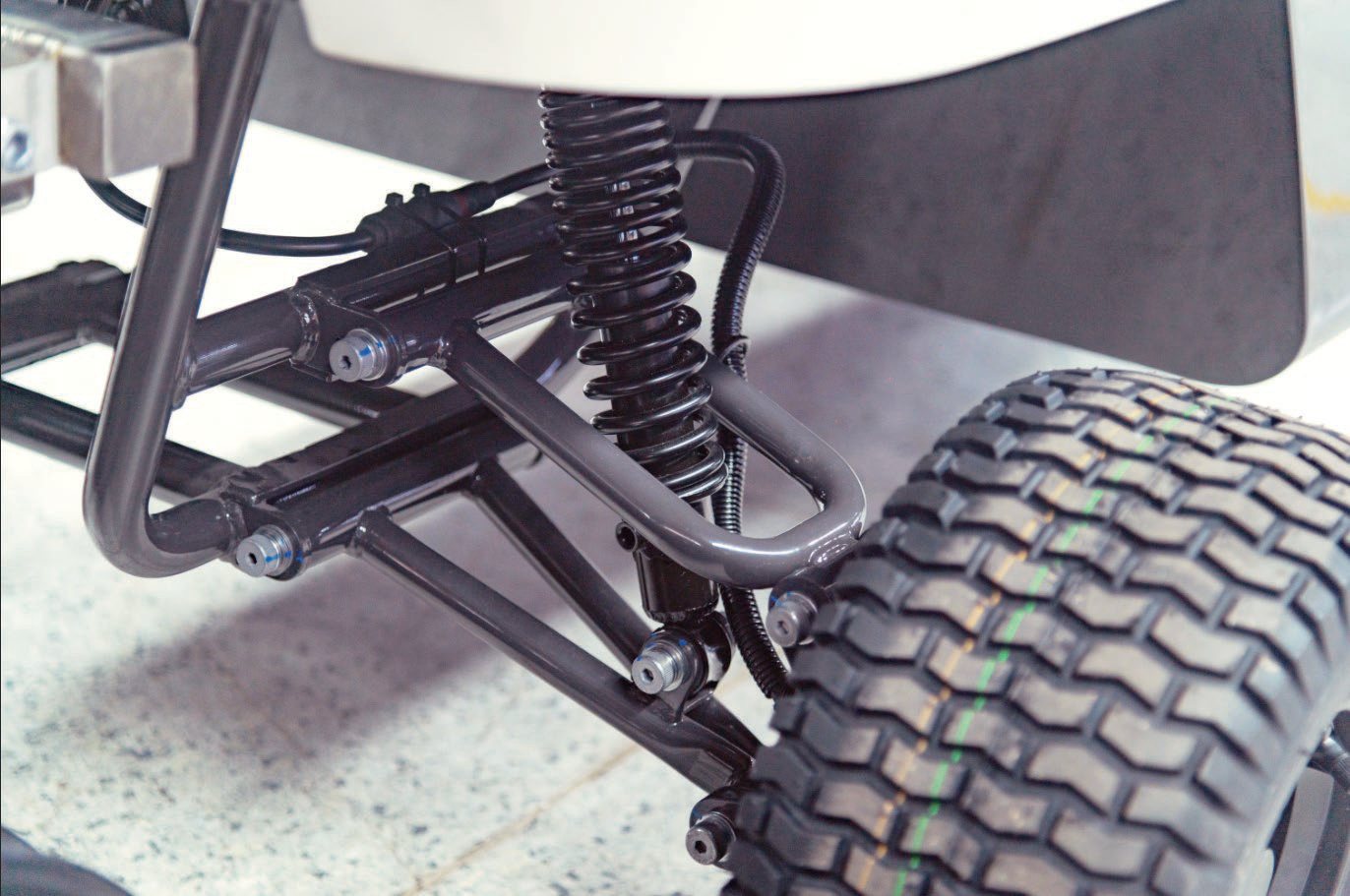 Close-up of the WayPick golf ball collection robot suspension, drive wheel and chassis